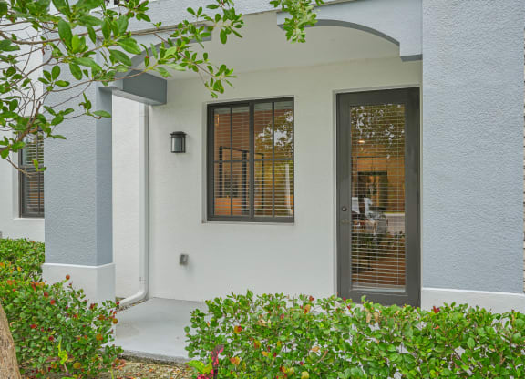 the front entrance of a house with a door and windows at Edge75, Naples, Florida 34104