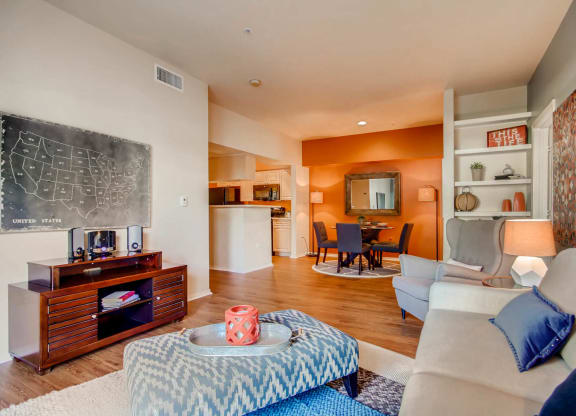 a living room with a chalkboard on the wall and a couch at Heritage at Stone Mountain, Northglenn, CO, 80233