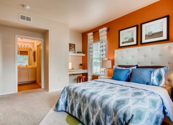 a bedroom with a bed and a bathroom at Heritage at Stone Mountain, Northglenn, CO, 80233