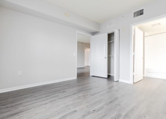 a bedroom with hardwood floors and white walls at Heritage Bay, Florida