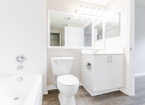 a bathroom with a white sink and toilet and a white bathtub at Heritage Bay, Florida