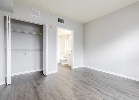 a bedroom with a medium sized bed and a closet with a sliding door at Heritage Bay, Jensen Beach, 34957