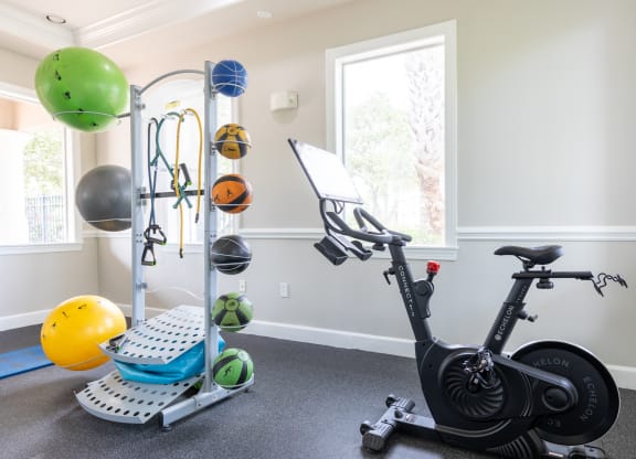 a home gym with an exercise bike and weights at Heritage Bay, Jensen Beach, 34957