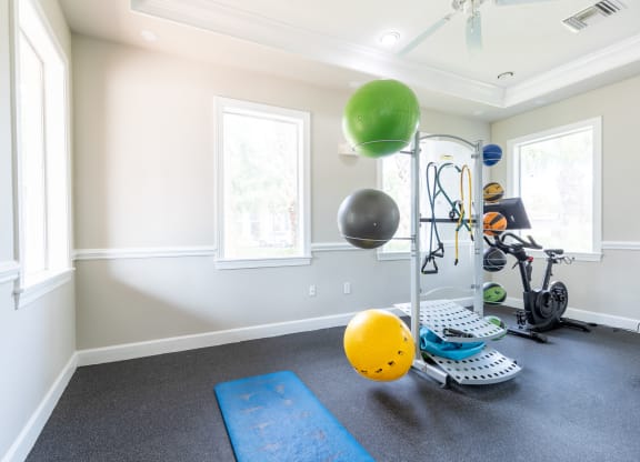 a home gym with a treadmill and exercise balls at Heritage Bay, Jensen Beach, 34957
