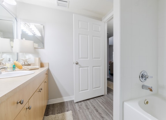 a bathroom with a bathtub and a sink at Heritage Bay, Jensen Beach, FL