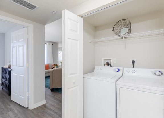a washer and dryer in a room with a living room in the background at Heritage Bay, Jensen Beach Florida