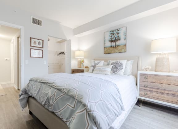 a bedroom with a bed and a dresser with a mirror at Heritage Bay, Jensen Beach Florida