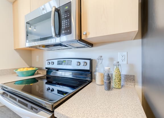 a kitchen with a stove and microwave in a 555 waverly unit at Heritage Bay, Jensen Beach, FL 34957