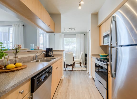 a kitchen with wooden cabinets and stainless steel appliances at Heritage Bay, Jensen Beach, FL 34957