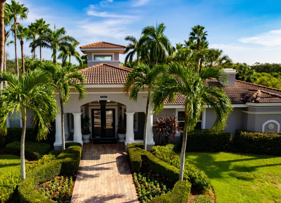a house with palm trees in front of it at Heritage Bay, Jensen Beach, FL 34957