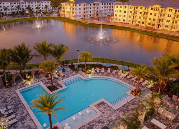 Sunset Drone View of Buildings, Pool, and Lake at Edge75, Naples, FL 34104