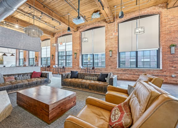 a large living room with couches and a coffee table at Riverwalk Apartments, Lawrence, MA