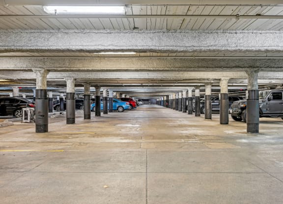 an empty parking garage with cars parked in it at Riverwalk Apartments, Lawrence, MA