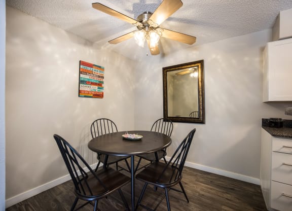 Dining area with a table and four chairs at Windmill Apartments, Colorado, 80916