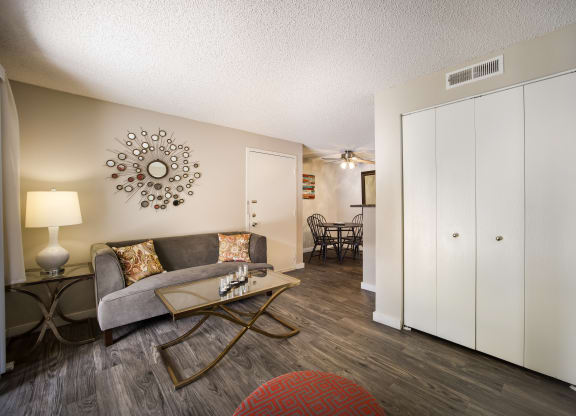 Living room with a couch and coffee table at Windmill Apartments, Colorado, 80916