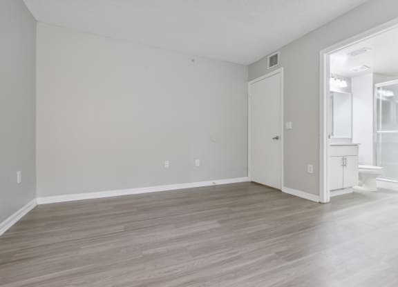 an empty living room with white walls and wood flooring at Pembroke Pines Landings, Pembroke Pines