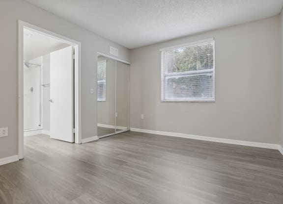 an empty living room with wood floors and a window at Pembroke Pines Landings, Florida