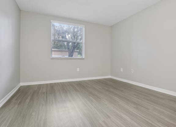 an empty room with wood floors and a window at Pembroke Pines Landings, Florida