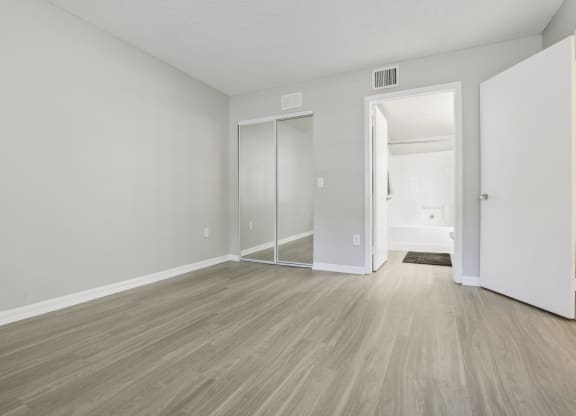 an empty living room with white walls and wood flooring at Pembroke Pines Landings, Pembroke Pines