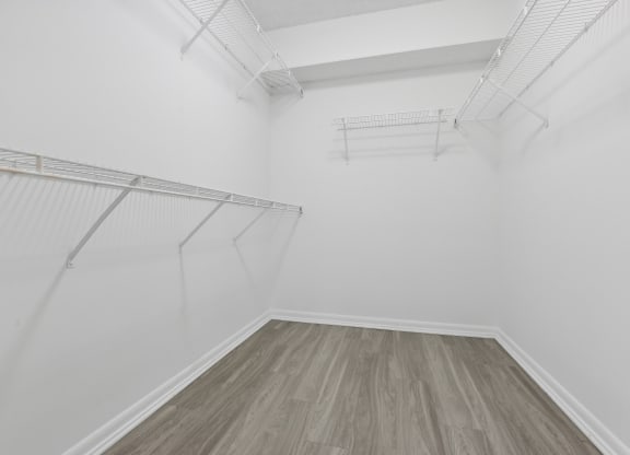 a room with white walls and wood floors and a white closet at Pembroke Pines Landings, Pembroke Pines, Florida
