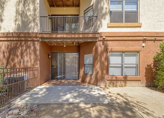 A building with a balcony and a gate.