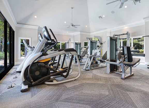 A spacious home gym with a variety of equipment.