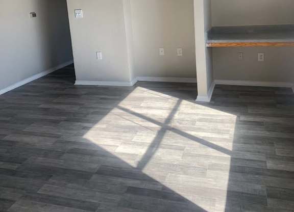 A room with a ceiling fan and a large window.at Chapel Ridge of Stillwater, Stillwater, 74075