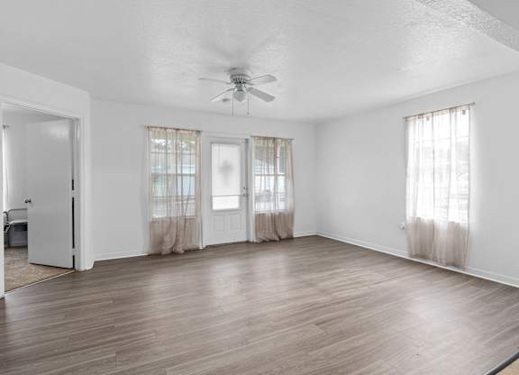 the living room of an empty house with a ceiling fan at The Groves at Wimauma Apartments , Wimauma