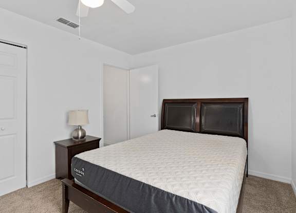 a bedroom with a bed and a closet at The Groves at Wimauma Apartments , Florida 33598