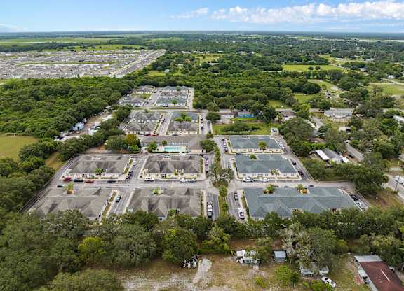 an aerial view of an empty parking lot in a city at The Groves at Wimauma Apartments , Wimauma, FL