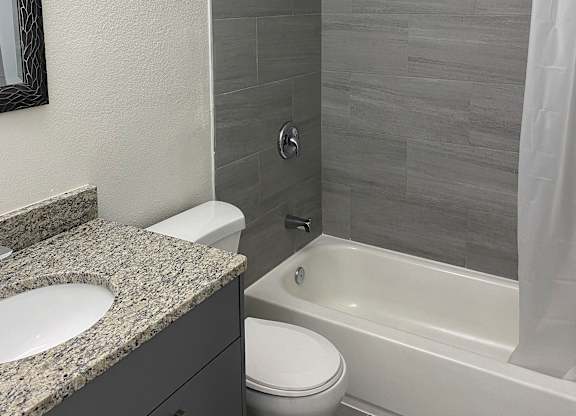 a bathroom with a sink toilet and bathtub at Colonial Drive Apartments, Orlando, FL 32808