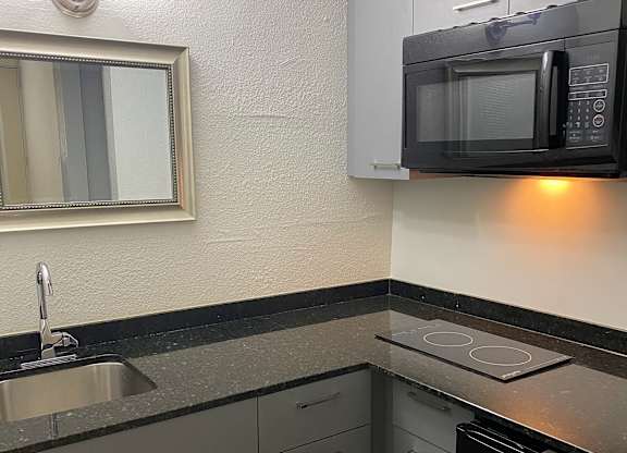 a kitchen with a sink and a microwave at Colonial Drive Apartments, Orlando, FL 32808