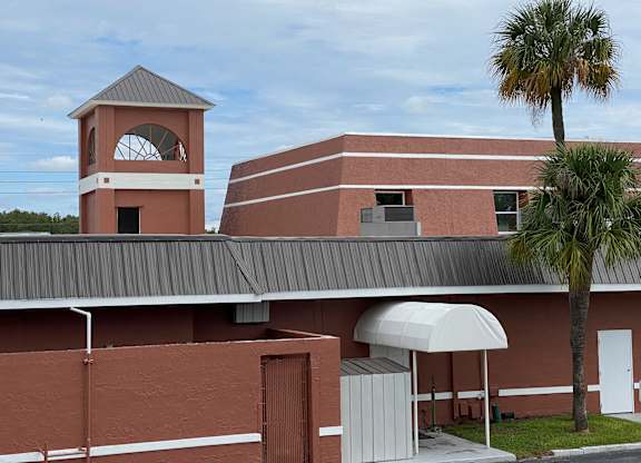 a picture of a building with a clock tower in the background at Colonial Drive Apartments, Orlando, FL 32808