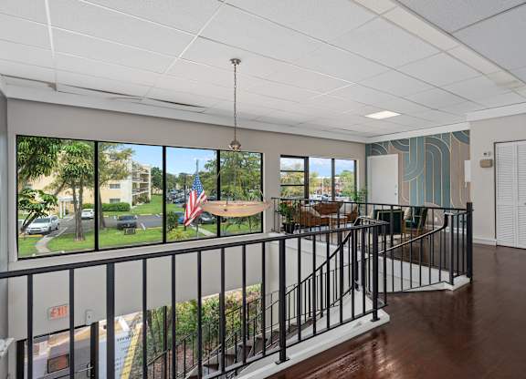 a lobby with a view of a yard and a table and chairs  at Cypress Grove, Lauderhill, 33313