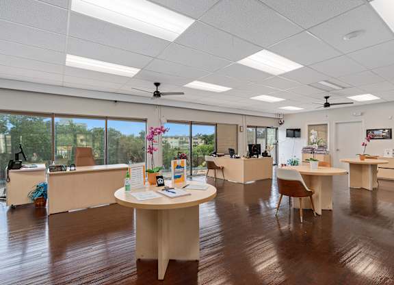 an office space with desks and chairs and a large window at Cypress Grove, Florida