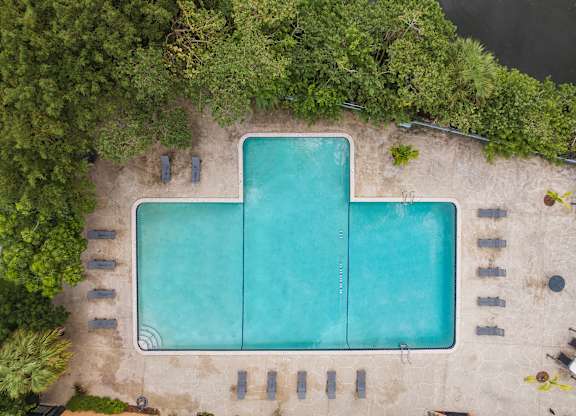 an overhead view of an infinity pool with trees and a blue water at Cypress Grove, Lauderhill, 33313