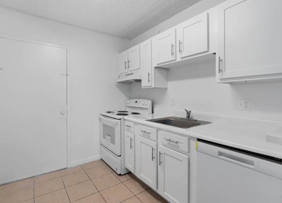 a white kitchen with white cabinets and a sink at Cypress Grove, Lauderhill, 33313