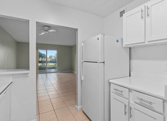 a kitchen with white cabinets and a white refrigerator at Cypress Grove, Lauderhill, 33313