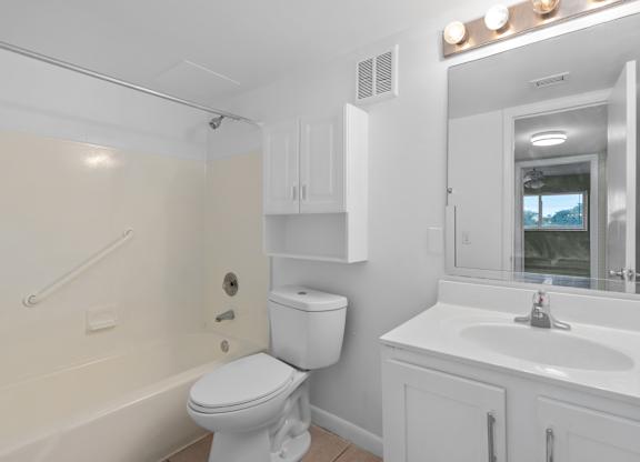 a bathroom with a toilet and a sink and a bath tub at Cypress Grove, Lauderhill, FL, 33313