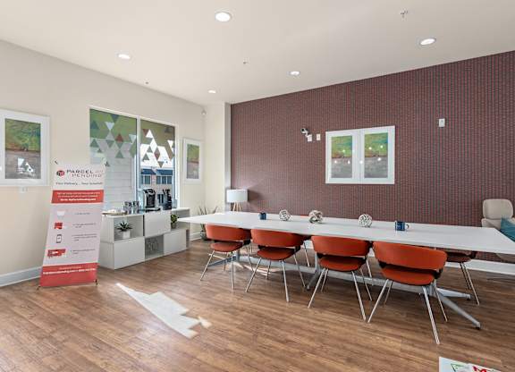 a conference room with a long table and chairs at Lake Lofts at Deerwood, Jacksonville, FL, 32216
