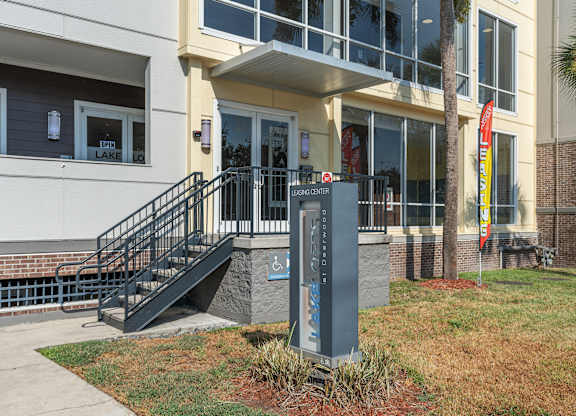 the front of a building with a sign in front of itat Lake Lofts at Deerwood, Jacksonville, FL