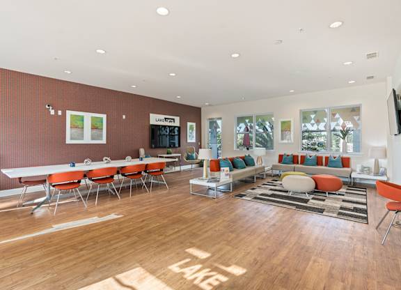 a living room with tables and chairs and a couch at Lake Lofts at Deerwood, Jacksonville, Florida