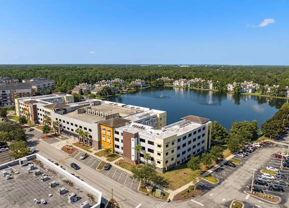 an aerial view of a building next to a lake at Lake Lofts at Deerwood, Jacksonville, FL, 32216