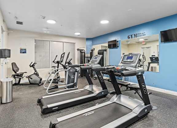 a gym with treadmills and other exercise equipment in a building at Lake Lofts at Deerwood, Jacksonville, FL