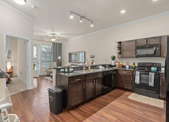 a kitchen with a large island and a living room at Lake Lofts at Deerwood, Jacksonville, 32216