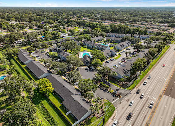 an aerial view of a neighborhood with cars parked in a parking lot at Oak Reserve at Winter Park, Winter Park, FL