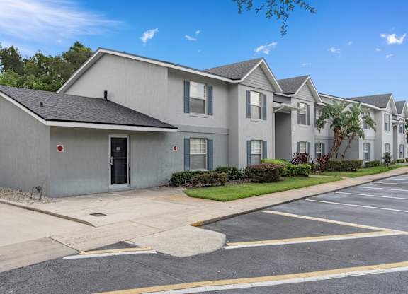 a white house with a street and a parking lot at Oak Reserve at Winter Park, Winter Park, 32792