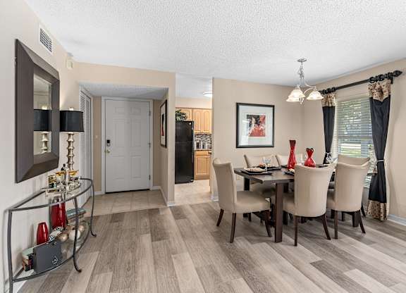the living room and dining room of a home with a table and chairs at Oak Reserve at Winter Park, Florida