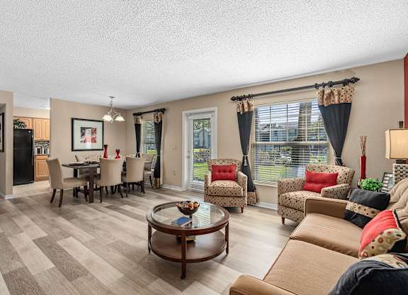 a living room with couches and chairs and a dining room table at Oak Reserve at Winter Park, Florida, 32792