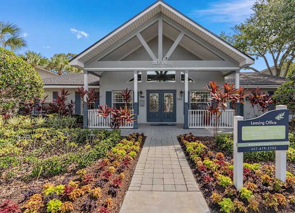 the entrance to a building with a sign in front of it at Oak Reserve at Winter Park, Florida